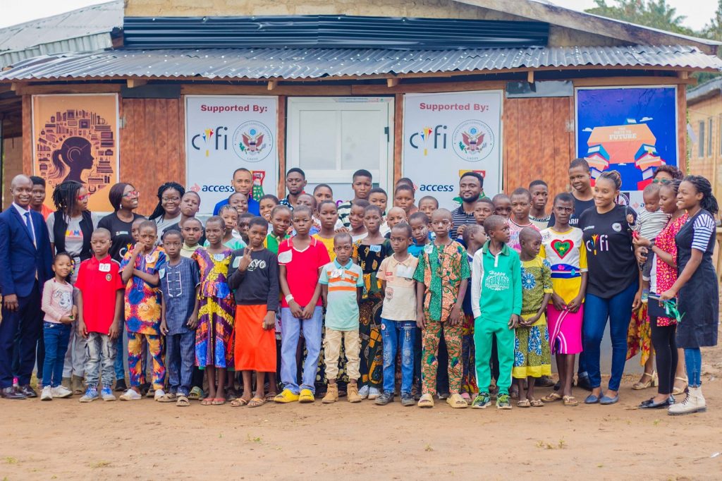 Children and adults taking pictures with the new library.